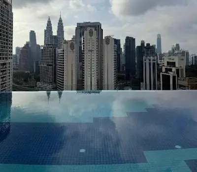 a swimming pool with a view of a city at Majestic Residence KLCC in Kuala Lumpur