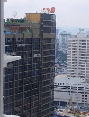a tall building with a sign on top of it at Majestic Residence KLCC in Kuala Lumpur