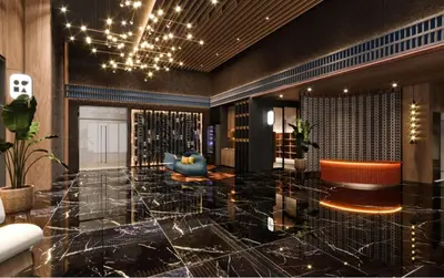 a lobby with a large marble floor with a couch and chairs at Majestic Residence KLCC in Kuala Lumpur