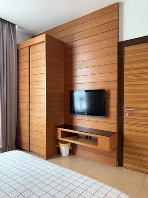 a room with a flat screen tv in a wooden wall at Family Suites KL Sentral in Kuala Lumpur