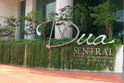 a sign for a hotel in front of a building at Family Suites KL Sentral in Kuala Lumpur