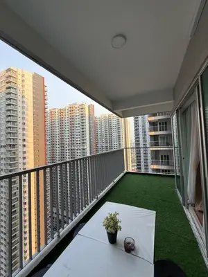 a balcony with a table and a view of buildings at Razak City Residence KL City in Kuala Lumpur