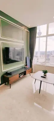 a living room with a large television and a table at Sky Suites KLCC by TD Luxe Global in Kuala Lumpur