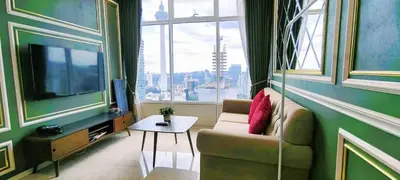 a living room with a couch and a large window at Sky Suites KLCC by TD Luxe Global in Kuala Lumpur