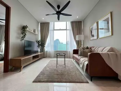 a living room with a couch and a ceiling fan at Nook Sky Suites KLCC in Kuala Lumpur