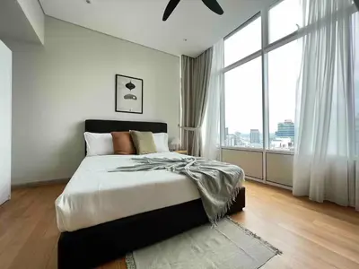 a bedroom with a large bed and a large window at Nook Sky Suites KLCC in Kuala Lumpur