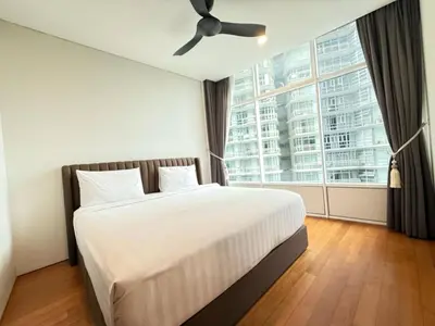 a bedroom with a bed and a large window at Nook Sky Suites KLCC in Kuala Lumpur
