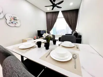 a white dining room table with white plates on it at Nook Sky Suites KLCC in Kuala Lumpur