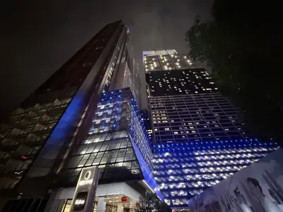 a tall building with blue lights on it at night at Platinum Suites Kuala Lumpur Malaysia By LuzBnB in Kuala Lumpur