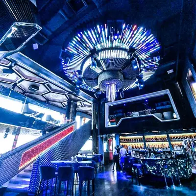 a room with a bar with chairs and a chandelier at Platinum Suites Kuala Lumpur Malaysia By LuzBnB in Kuala Lumpur
