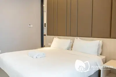 a white towel sitting on top of a bed at Societe Suites Hartamas by Plush in Kuala Lumpur