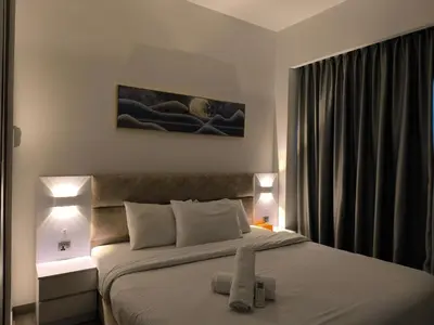 a bedroom with a large bed with two lamps at Sky View Agile Residence Bukit Bintang KL in Kuala Lumpur