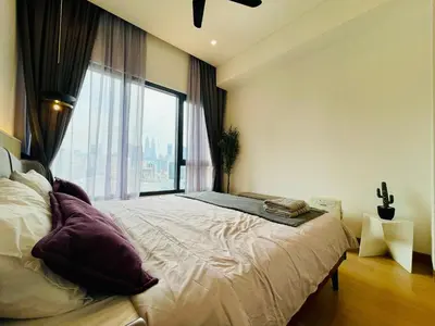 a bedroom with a large bed with a large window at Lucentia Residences By ONZO in Kuala Lumpur