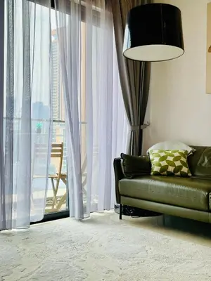 a living room with a couch and a large window at Lucentia Residences By ONZO in Kuala Lumpur