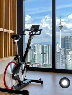 a exercise bike in a room with a large window at Lucentia Residences By ONZO in Kuala Lumpur