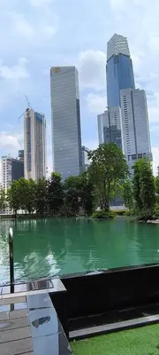 a green body of water in a city with tall buildings at Service Residence Agile Delima Residence KL in Kuala Lumpur