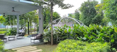 a patio with chairs and a fountain in a garden at Service Residence Agile Delima Residence KL in Kuala Lumpur