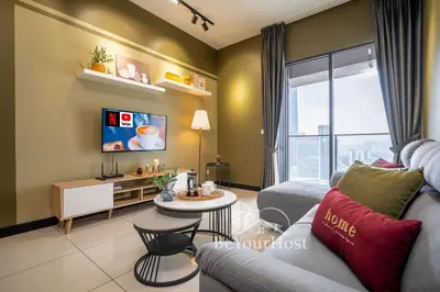 a living room with a couch and a table at Continew Residences Kuala Lumpur in Kuala Lumpur
