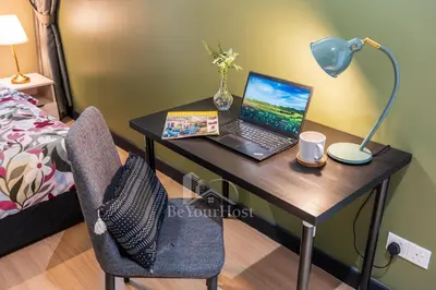 a desk with a laptop and a lamp on it at Continew Residences Kuala Lumpur in Kuala Lumpur