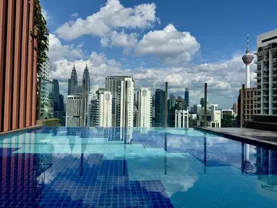 a swimming pool with a view of a city at The Majestic Residence Kuala Lumpur in Kuala Lumpur