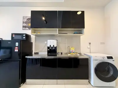 a kitchen with a refrigerator and a washing machine at The Majestic Residence Kuala Lumpur in Kuala Lumpur