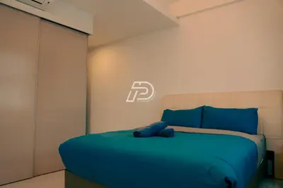 a bedroom with a bed with a blue blanket at KL Hartamas 2BR Wifi Smart TV in Kuala Lumpur