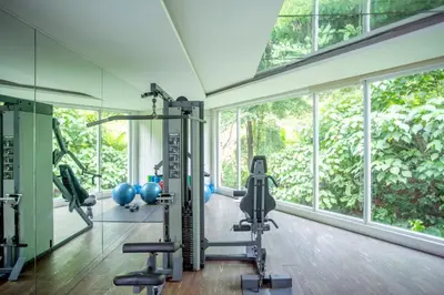 a gym with exercise equipment and a large window at KL Hartamas 2BR Wifi Smart TV in Kuala Lumpur