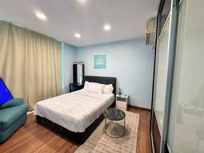 a small bedroom with a bed and a couch at Taragon Puteri Bintang KL in Kuala Lumpur