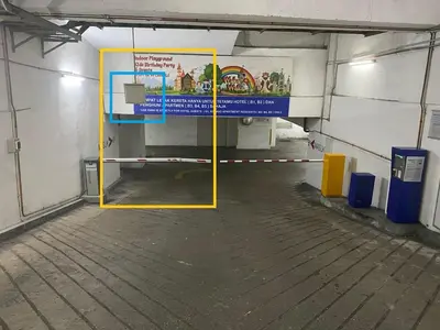 a parking lot with a yellow door in a parking garage at Taragon Puteri Bintang KL in Kuala Lumpur