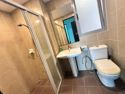 a bathroom with a toilet and a sink and a shower at Taragon Puteri Bintang KL in Kuala Lumpur