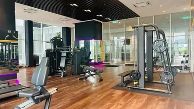 a gym with treadmills and exercise equipment in a building at Quill Residence KLCC By UrbanNest in Kuala Lumpur