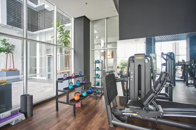 a gym with a treadmill and a large window at Quill Residence KLCC By UrbanNest in Kuala Lumpur