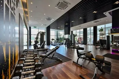 a gym with a bunch of treadmills and machines at Quill Residence KLCC By UrbanNest in Kuala Lumpur