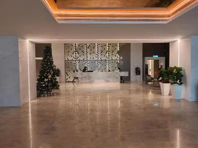 a lobby with a christmas tree in the middle at Quill Residence KLCC By UrbanNest in Kuala Lumpur