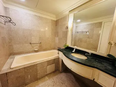 a bathroom with a tub and a sink and a bath tub at Times Square KL Serviced Suite in Kuala Lumpur