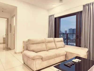 a living room with a couch and a large window at Cozy couple suite 1601A at KLCC in Kuala Lumpur