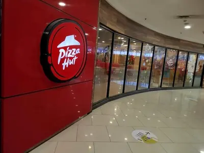 a pizza hut sign on the wall of a store at Quill Residence KLCC Suites City Home in Kuala Lumpur