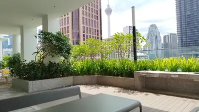a balcony with a view of a city skyline at Quill Residence KLCC Suites City Home in Kuala Lumpur
