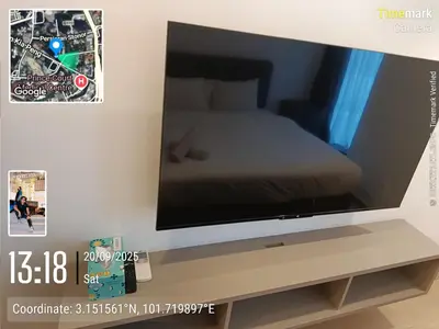 a flat screen tv on a stand with a bed at Eaton resident full luxury in Kuala Lumpur