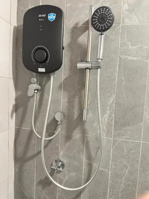 a shower with a hair dryer attached to a wall at Luxury couple suite 1906B at KLCC in Kuala Lumpur