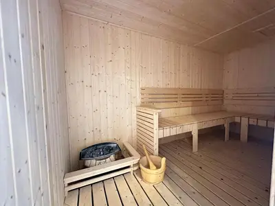 a sauna with a bench and a fire pit at Luxury couple suite 1906B at KLCC in Kuala Lumpur