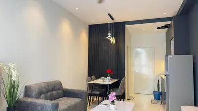 a living room with a chair and a table at Luxury couple suite 1906B at KLCC in Kuala Lumpur