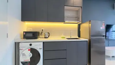 a kitchen with a dish washer and a refrigerator at Luxury couple suite 1906B at KLCC in Kuala Lumpur