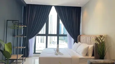 a bedroom with a bed and a large window at Luxury couple suite 1906B at KLCC in Kuala Lumpur