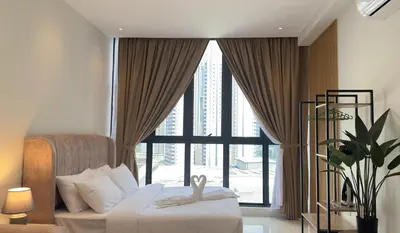 a bedroom with a bed and a large window at Luxury couple suite 1906A at KLCC in Kuala Lumpur