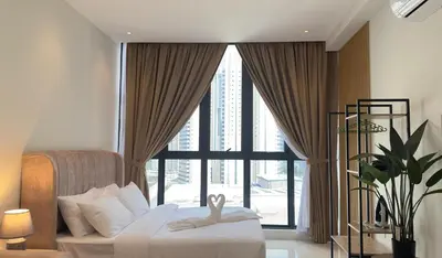 a bedroom with a bed and a large window at Luxury couple suite 1906A at KLCC in Kuala Lumpur