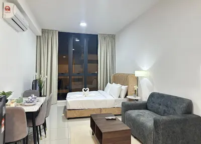 a living room with a bed and a couch and a table at KLCC view suite 1601B at Majestic Residence in Kuala Lumpur