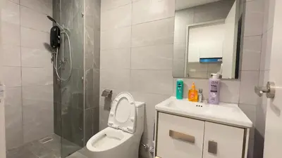 a bathroom with a toilet and a shower and a sink at KLCC view suite 1601B at Majestic Residence in Kuala Lumpur