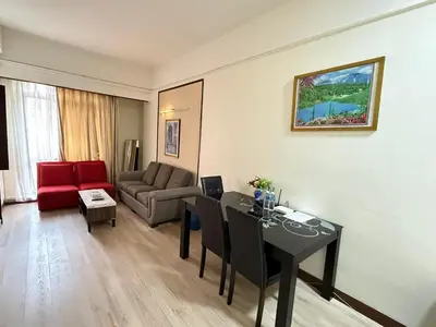 a living room with a table and a couch at Signature Suite at Time Square by Regal in Kuala Lumpur