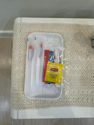 a plastic container with toothbrushes and a box of toothpaste at PWTC Chamber Rock by AZ Line in Kuala Lumpur